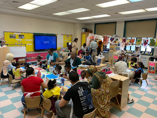 Families painting together during paint night event